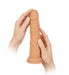 Hands holding a realistic flesh-toned silicone Turbo Shaft vibrator with textured surface and suction base.