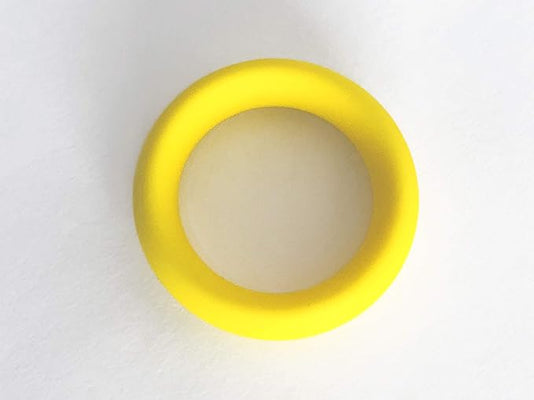 Bright yellow flexible cock ring with smooth surface, designed for comfortable and secure wear.