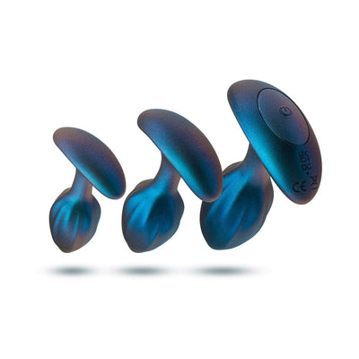 Set of three graduated lunar blue silicone plugs with ergonomic bases, including a vibrating plug with power button.