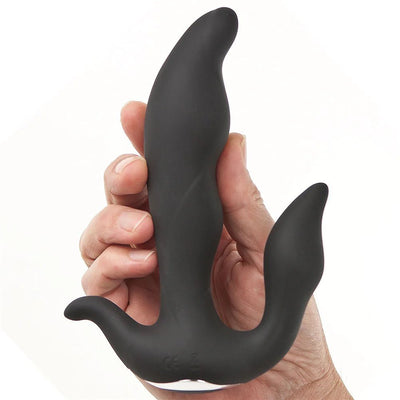 Hand holding black silicone prostate massager with three curved stimulation points and ergonomic design.
