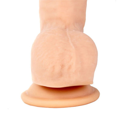 Beige realistic textured dildo with suction cup base standing upright on white background.