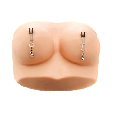 Silver adjustable nipple clamps with beaded weights displayed on a silicone breast model against a white background.