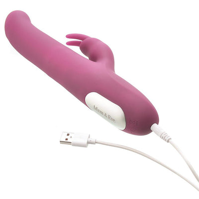 Pink Adam & Eve Eves Twirling Rabbit Thruster vibrator with USB charging cable on white background.