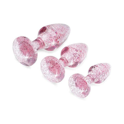 Set of three pink glittery acrylic butt plugs in small, medium, and large sizes with gem-shaped bases on white background.