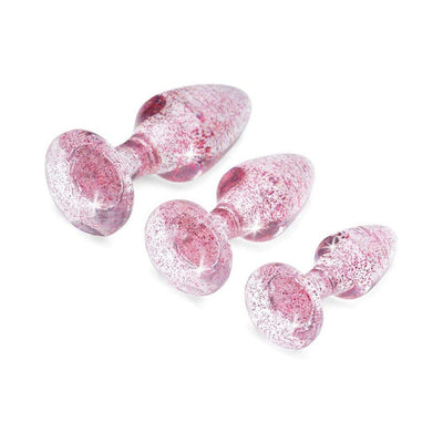 Set of three pink glitter acrylic butt plugs in small, medium, and large sizes with gem-shaped bases on white background.