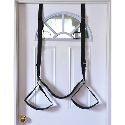 Black adjustable couples door swing with padded seat and stirrups hanging over a white interior door.