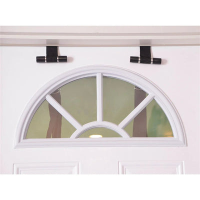 Black padded anchors of Adam & Eve Naughty Couples Door Swing hanging over the top of a white door with a semicircular window.