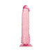 Pink translucent realistic dildo with textured veins and suction cup base standing upright on white background