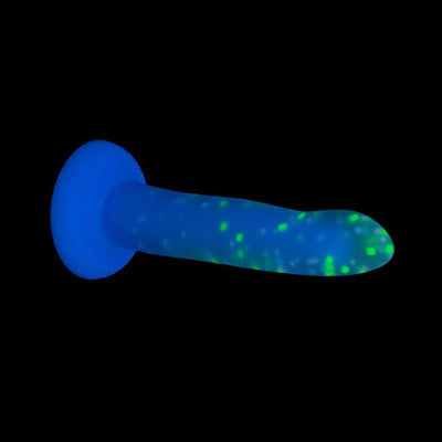 Glow-in-the-dark blue silicone toy with green confetti specks and suction cup base against black background.