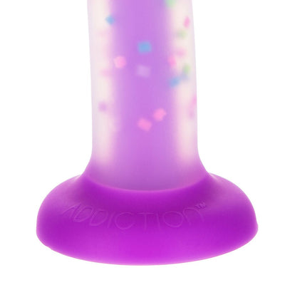 Close-up of the purple suction cup base of the Addiction Rave Party Marty Dong with a confetti pattern on the glow-in-the-dark shaft.