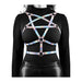 Rainbow-colored adjustable chest harness with rose gold hardware worn over a black long-sleeve top and leather pants