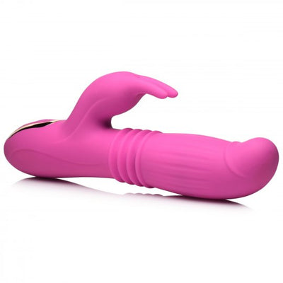 Pink silicone rabbit vibrator with textured thrusting shaft and curved clitoral stimulator on white background.