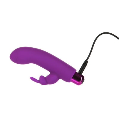Purple silicone rabbit sleeve vibrator with curved tip, attached to a metallic pink bullet and connected to a charging cable.
