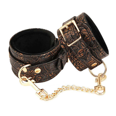 Brown floral print PU ankle restraints with soft black faux fur lining and gold-tone chain and hardware.