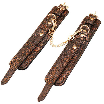 Brown floral embossed PU ankle restraints with gold hardware and soft black faux fur lining connected by a gold chain