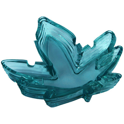 Stack of translucent blue glass ashtrays shaped like pot leaves with notches for resting smoking items.