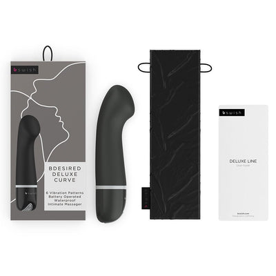 B Swish Bdesired Deluxe Curve personal massager with packaging, black storage pouch, and user guide on white background.