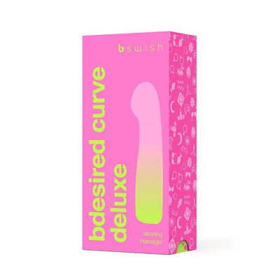 Packaging box of B Swish Bdesired Deluxe Curve personal massager in bright pink with green text and product silhouette.