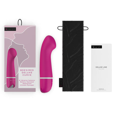 B Swish Bdesired Deluxe Curve personal massager in pink with packaging, black storage pouch, and user guide.