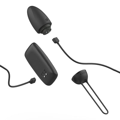 Black B Swish Bnaughty Premium Unleashed bullet massager with wireless remote and charging cable on white background.