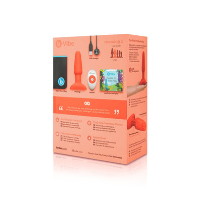 B-Vibe Rimming Plug 2 packaging showing plug, remote, USB charger, travel bag, and guide to anal play on a peach background.