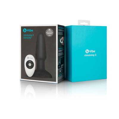 B-Vibe Rimming Plug 2 with remote control shown in black packaging and bright blue box on white background.