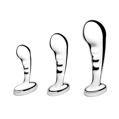 Set of three polished stainless steel prostate plugs in small, medium, and large sizes with curved, ridged design and wide bases.