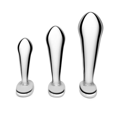 Set of three polished stainless steel prostate plugs in small, medium, and large sizes with tapered tips and wide bases.