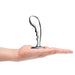 Hand holding a polished stainless steel prostate plug with a curved, ergonomic design and textured grip.