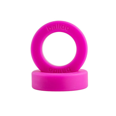 Bright pink Balldo spacer rings stacked, one upright and one flat, with embossed branding on the ring.
