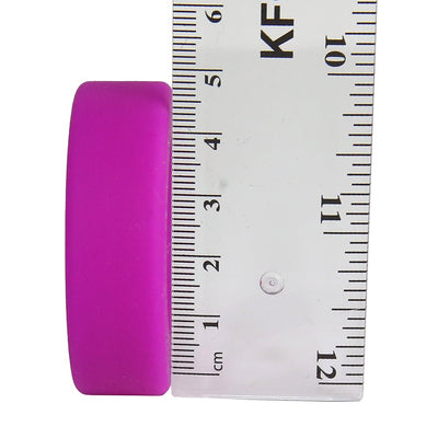 Purple Balldo spacer ring next to a clear ruler showing its thickness at about 2 cm.
