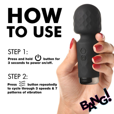 Hand holding black textured mini silicone wand with usage instructions for power and vibration settings.
