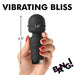 Hand holding a black mini silicone wand vibrator with 4.5 inch length and 1.6 inch head diameter, showing control buttons.
