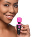 Smiling woman holding a compact pink and black BANG! 10X Vibrating Mini Wand with flexible neck and single button.