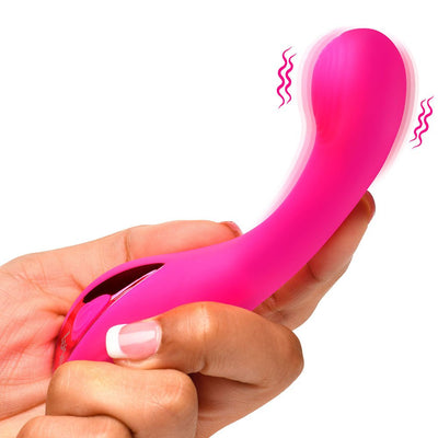 Hand holding a bright pink curved silicone G-spot vibrator with vibration motion lines.