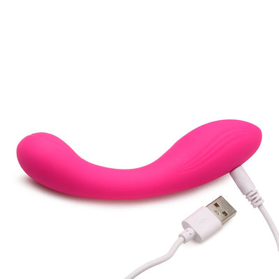 Pink curved silicone vibrator with textured head, shown with white USB charging cable on white background.