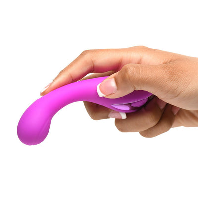 Hand holding a curved purple silicone G-spot vibrator with control buttons visible, shown against a white background.