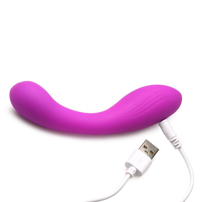 Purple curved G-spot silicone vibrator with USB charging cable on white background.