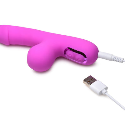 Pink mini rabbit vibrator with curved clit suction arm and USB charging cable on white background.
