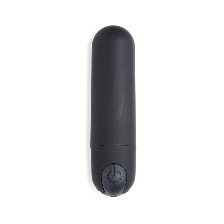 Compact black vibrating bullet with smooth silicone finish and power button on base, designed for discreet pleasure.
