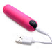 Pink vibrating bullet with black power button connected to white USB charging cable on white background