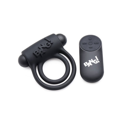 Black silicone vibrating cock ring with dual rings and bullet, paired with a compact remote control featuring multiple buttons.
