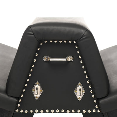 Close-up of black faux leather bondage bench corner with silver metal studs and attachment points.