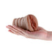 Hand holding a compact, textured flesh-colored stroker with a soft, realistic design and closed-ended opening.