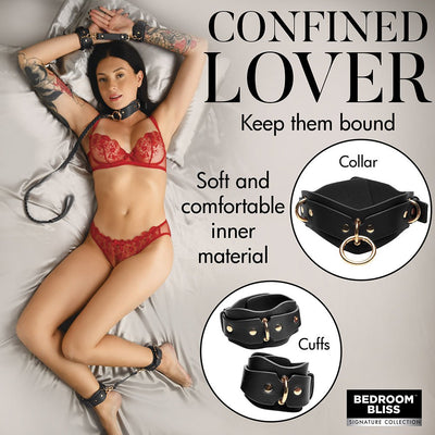 Woman in red lingerie wearing black vegan leather collar, wrist and ankle cuffs with gold hardware on silver satin sheets.