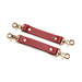 Red vegan leather cuff connectors with gold-tone metal clasps for adjustable restraint sets.