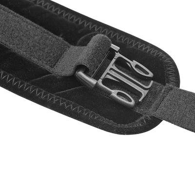 Close-up of black padded strap with adjustable hook and loop fastener and plastic buckle detail.