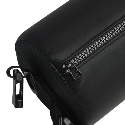 Close-up of black padded sex spreader bar with zipper and attached adjustable straps and clips in faux leather.