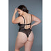 Plus size model wearing black sheer mesh bodysuit with adjustable straps and back cutout detail against gray background