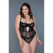Plus size model wearing black lace and mesh BeWicked Cameryn bodysuit with underwire cups and adjustable straps against gray background.